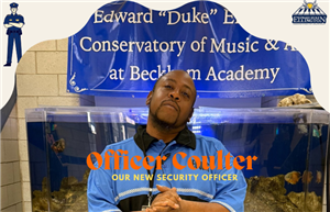  Picture of our new security guard Mr. Coulter standing in front of the fish tank.